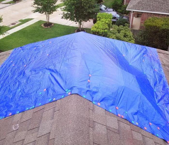Blue tarp on roof. Roof tarp service